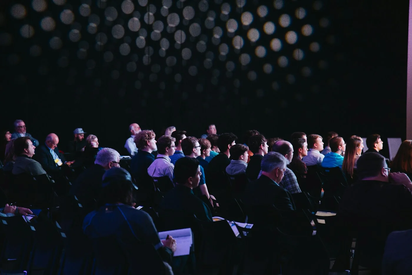 A lively conference audience connecting in a shared space
